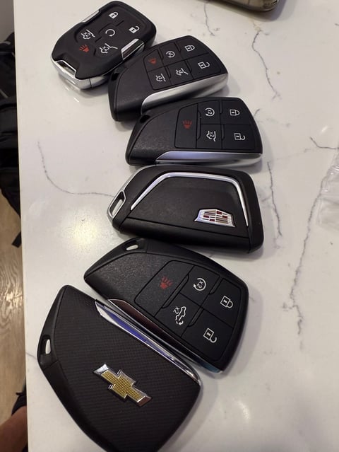 Six black Chevrolet car key fobs with various button configurations